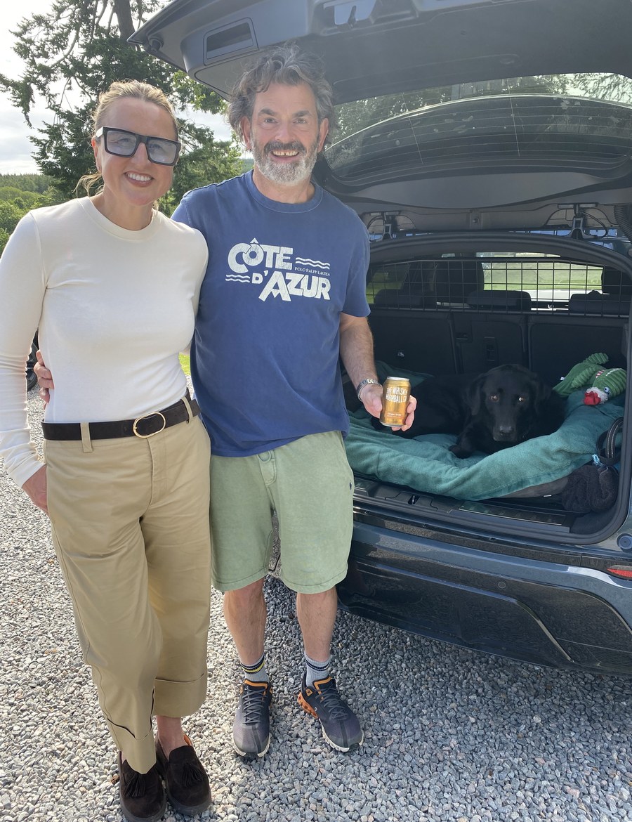 Man and woman with a can and their dog